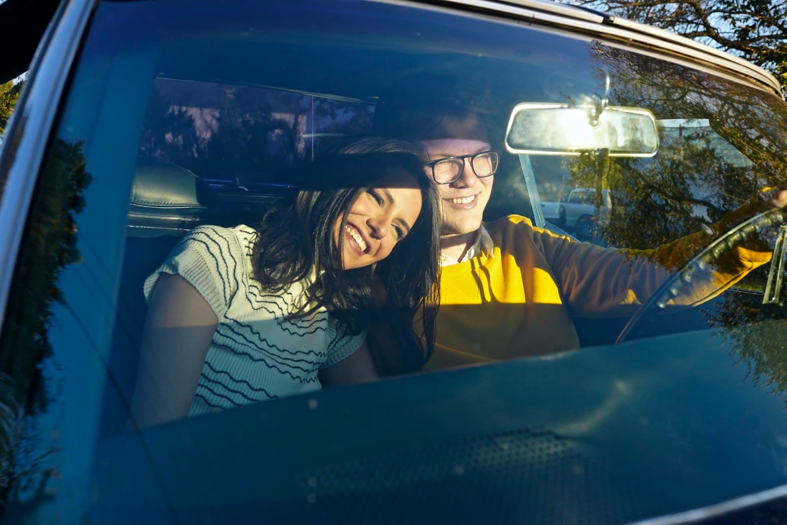 Two passengers sharing a ride, talking in the car